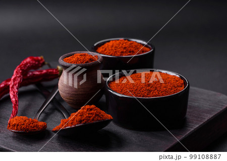 Spice smoked paprika in the form of powder in bowls and spoons Spice smoked paprika in the form of powder in bowls and spoons 99108887