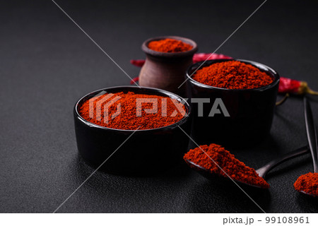 Spice smoked paprika in the form of powder in bowls and spoons Spice smoked paprika in the form of powder in bowls and spoons 99108961