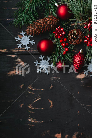 Christmass background red christmas tree toys,silver snowflake and spruce brance on wooden background. Christmass background red christmas tree toys,silver snowflake and spruce brance on wooden background. 99112718