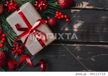 Christmass background gift boxe,red christmas tree toys,christmas decoration and spruce brance on wooden background. 99112719