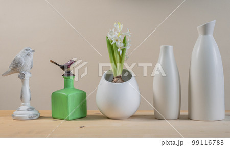 Spring Scandinavian cozy home decor: white vases, white hyacinth and bird figurines 99116783