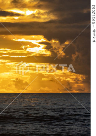 Cloudy yellow sunset over the dark sea Cloudy yellow sunset over the dark sea 99122063