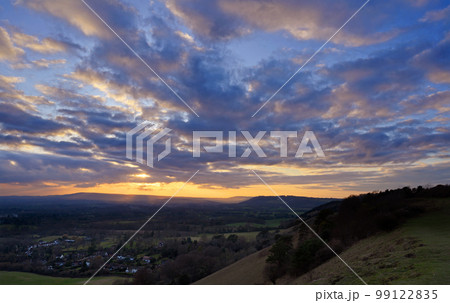Classic sunset view from Colley Hill between Reigate and Dorking in Surrey, UK. Surrey Hills area of Outstanding Natural Beauty on the North Downs. Looking towards Leith Hill on the Greensand Ridge. Classic sunset view from Colley Hill between Reigate and Dorking in Surrey, UK. Surrey Hills area of Outstanding Natural Beauty on the North Downs. Looking towards Leith Hill on the Greensand Ridge. 99122835