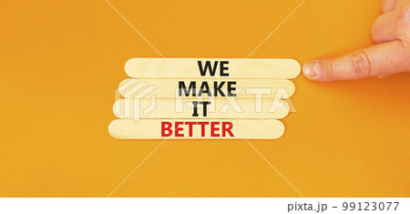 We make it better symbol. Concept words We make it better on wooden stick. Beautiful orange table orange background. Businessman hand. Business we make it better concept. Copy space. 99123077