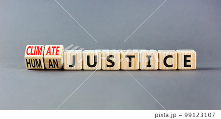 Climate or human justice symbol. Concept words Climate justice Human justice on wooden cubes. Beautiful grey table grey background. Ecological climate or human justice concept. Copy space. 99123107