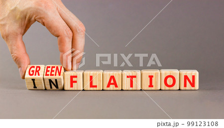 Inflation or greenflation symbol. Concept words Inflation or Greenflation on wooden cubes. Beautiful grey background. Businessman hand. Ecological business inflation greenflation concept. Copy space. 99123108