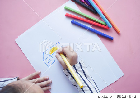top view of child girl drawing on paper sitting on floor top view of child girl drawing on paper sitting on floor 99124942