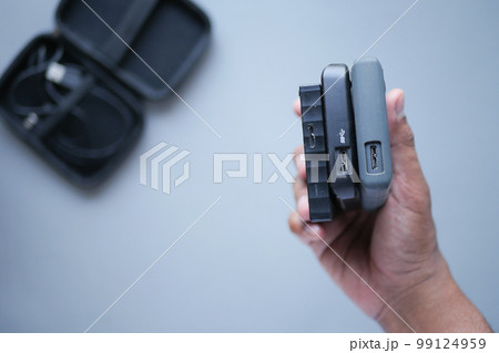holding a stack of external hard drives  99124959