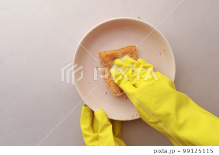 sponge , rubber gloves and colorful plate on blue  99125115
