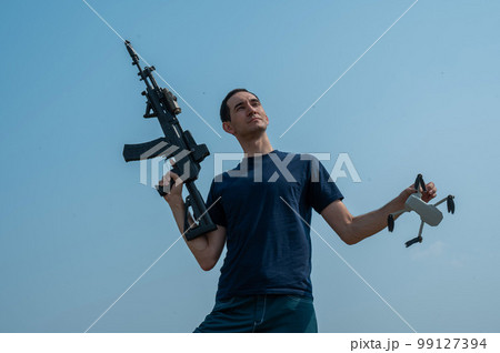 Caucasian man shot down a drone with a shot from a rifle.  99127394