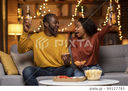 Emotional black lovers celebrating beginning of weekend at home 99127783