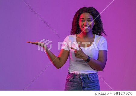 Check This. Smiling Young Black Woman Pointing At Her Open Empty Palm 99127970