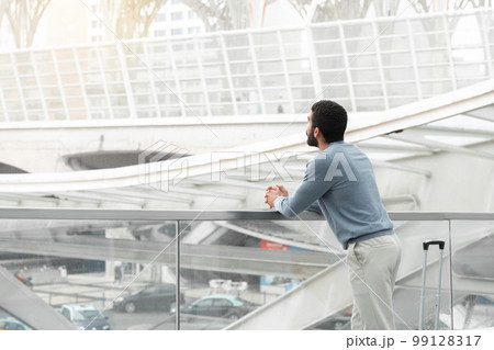 Unrecognizable Middle Eastern Male Traveler Standing With Suitcase At Airport 99128317