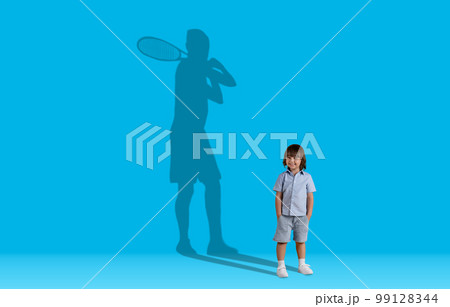 Tennis player shadow over cute smiling preschool boy 99128344