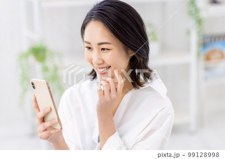 スマホを操作する若い女性 スマホを操作する若い女性 99128998