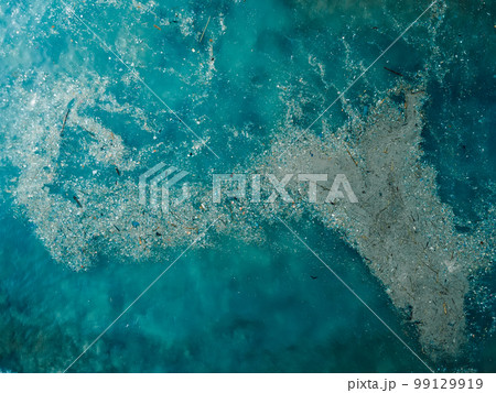 Ocean water and plastic trash island. Aerial view of pollution by rubbish 99129919