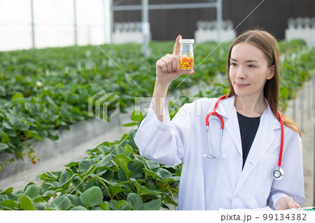 doctor scientist work research in organic herb farm lab discovery medicine pill extract from plant 99134382