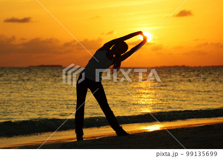 sunset yoga woman 99135699
