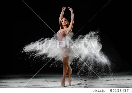 Young slim woman with spread flour on the air 99138457