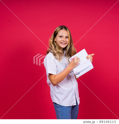 Child making notes. Kids dreams.Isolated on red background. Education, Kid back to school. 99140113