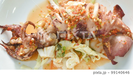 grilled squid dressing spicy and sour lemon sauce on plate grilled squid dressing spicy and sour lemon sauce on plate 99140646