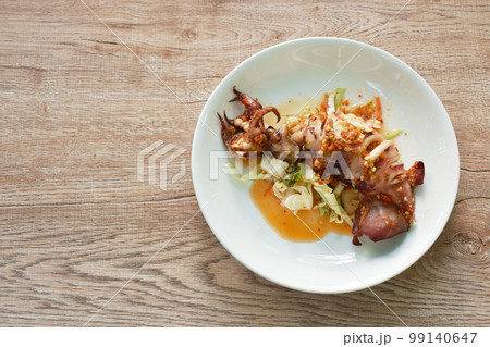 grilled squid dressing spicy and sour lemon sauce on plate grilled squid dressing spicy and sour lemon sauce on plate 99140647