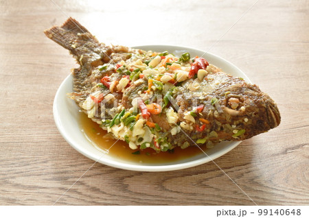 fried mango fish dressing spicy sauce herb sauce on plate fried mango fish dressing spicy sauce herb sauce on plate 99140648