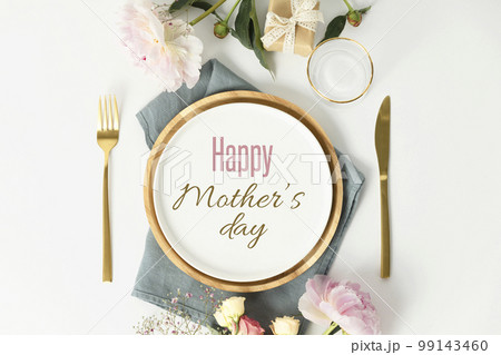 Happy Mother's day concept. Beautiful table setting with golden cutlery and peony flowers 99143460