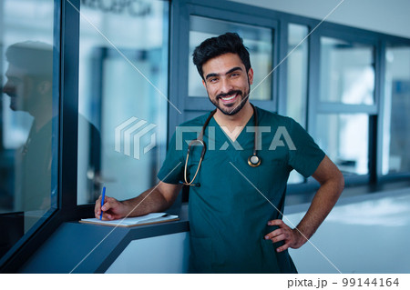 Portrait of young doctor at hospital room. 99144164