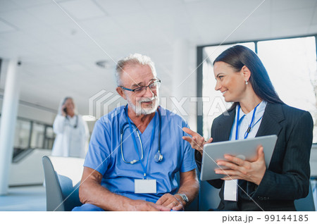 Young business woman shaking hand with elderly doctor. Young business woman shaking hand with elderly doctor. 99144185