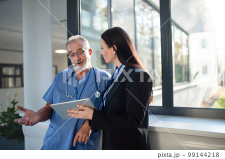 Young business woman shaking hand with elderly doctor. 99144218