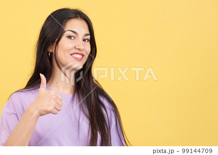 Happy caucasian woman gesturing agreement raising a thumb up Happy caucasian woman gesturing agreement raising a thumb up 99144709