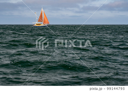 Sailboat on blue open sea with clouds on sky. Concept of travel, adventure and vacation. 99144793