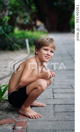 Boy blond freckles squatting sit smiling show gesture thumbs up shirtless bare chested shorts nature Boy blond freckles squatting sit smiling show gesture thumbs up shirtless bare chested shorts nature 99146061