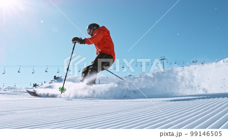 Alpine skier running down the hill. 99146505