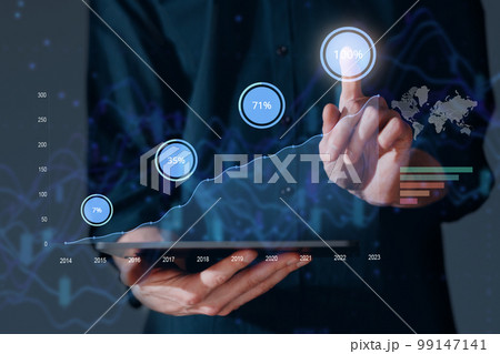 Virtual tablet PC screen with chart graph and businessman hand working on new business finance strategy concept 99147141