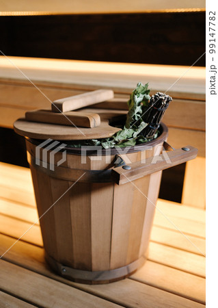 Close-up of various sauna accessories in a wooden sauna. Finnish sauna room with dry steam 99147782