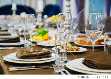 a festive served table with snacks and tableware. 99148833
