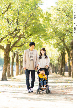 ベビーカーで散歩をする若い家族 99149623