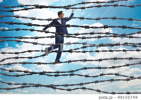 Businessman in barbed wire concept 99150749