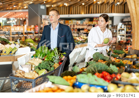 Couple shopping at vegetables department at supermarket Couple shopping at vegetables department at supermarket 99151741