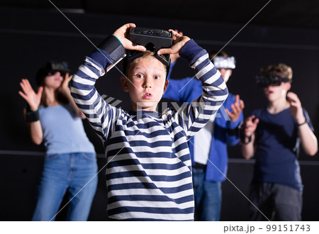 Portrait of a boy who took off his virtual reality glasses Portrait of a boy who took off his virtual reality glasses 99151743