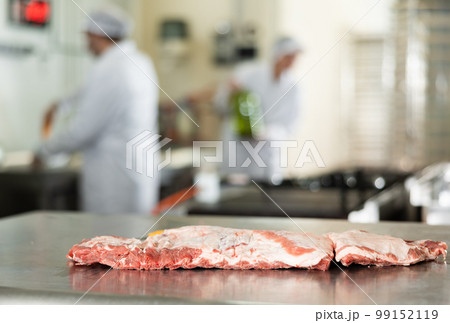 Fresh raw pork ribs on cutting table in butchery Fresh raw pork ribs on cutting table in butchery 99152119
