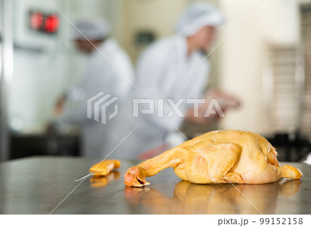 Raw dressed chicken lying on cutting table of butchers shop Raw dressed chicken lying on cutting table of butchers shop 99152158
