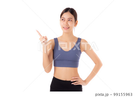 Portrait of beautiful young asian woman in sportwear smile and presenting isolated. 99155963