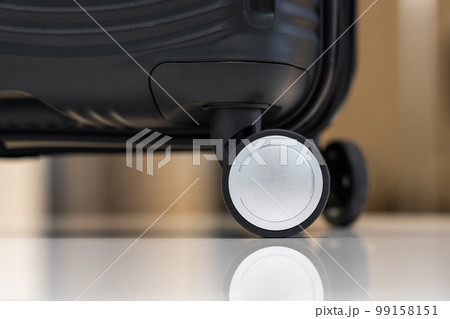 Close-up of black plastic travel carry-on suitcase on wheels 99158151