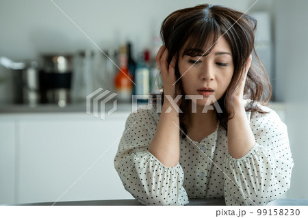 キッチンで悩むミドルの女性 キッチンで悩むミドルの女性 99158230