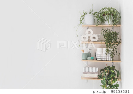 Beautiful white bathroom. Wooden shelves. Rolled towels, stacked towels and baskets. Soap, washcloth Beautiful white bathroom. Wooden shelves. Rolled towels, stacked towels and baskets. Soap, washcloth 99158581