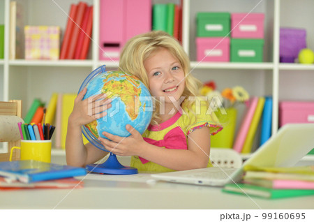 girl studying with a globe at the table girl studying with a globe at the table 99160695