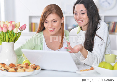 two female friends at desk two female friends at desk 99160805